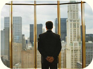 Man looking out office windows.